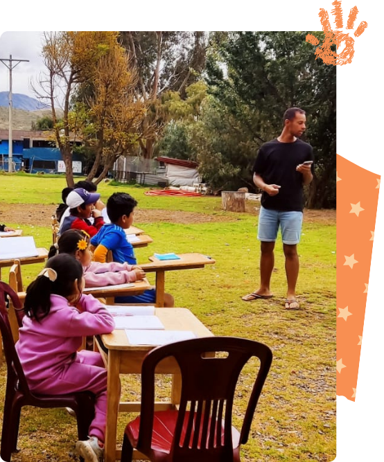 Children in class with a volunteer teacher